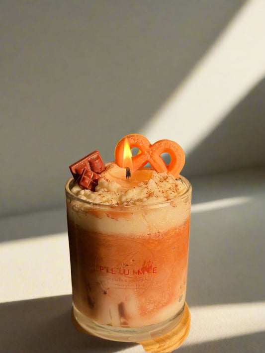 Candle in a glass holder with decorative elements on a dark background